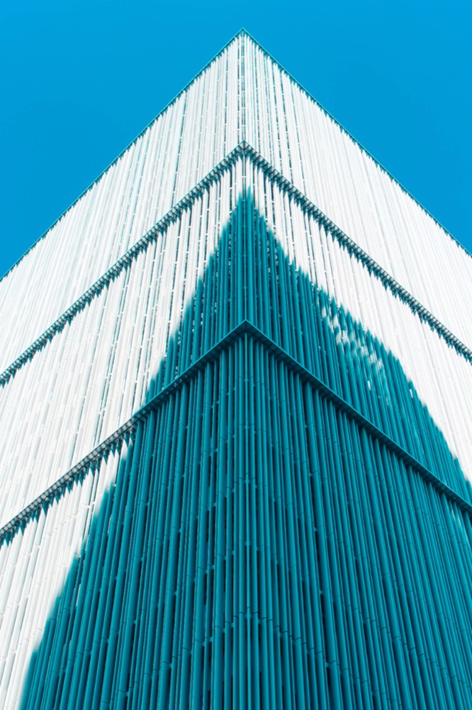 A glass-fronted corporate office building — a body corporate is a legal person in its own right, separate from its directors.
